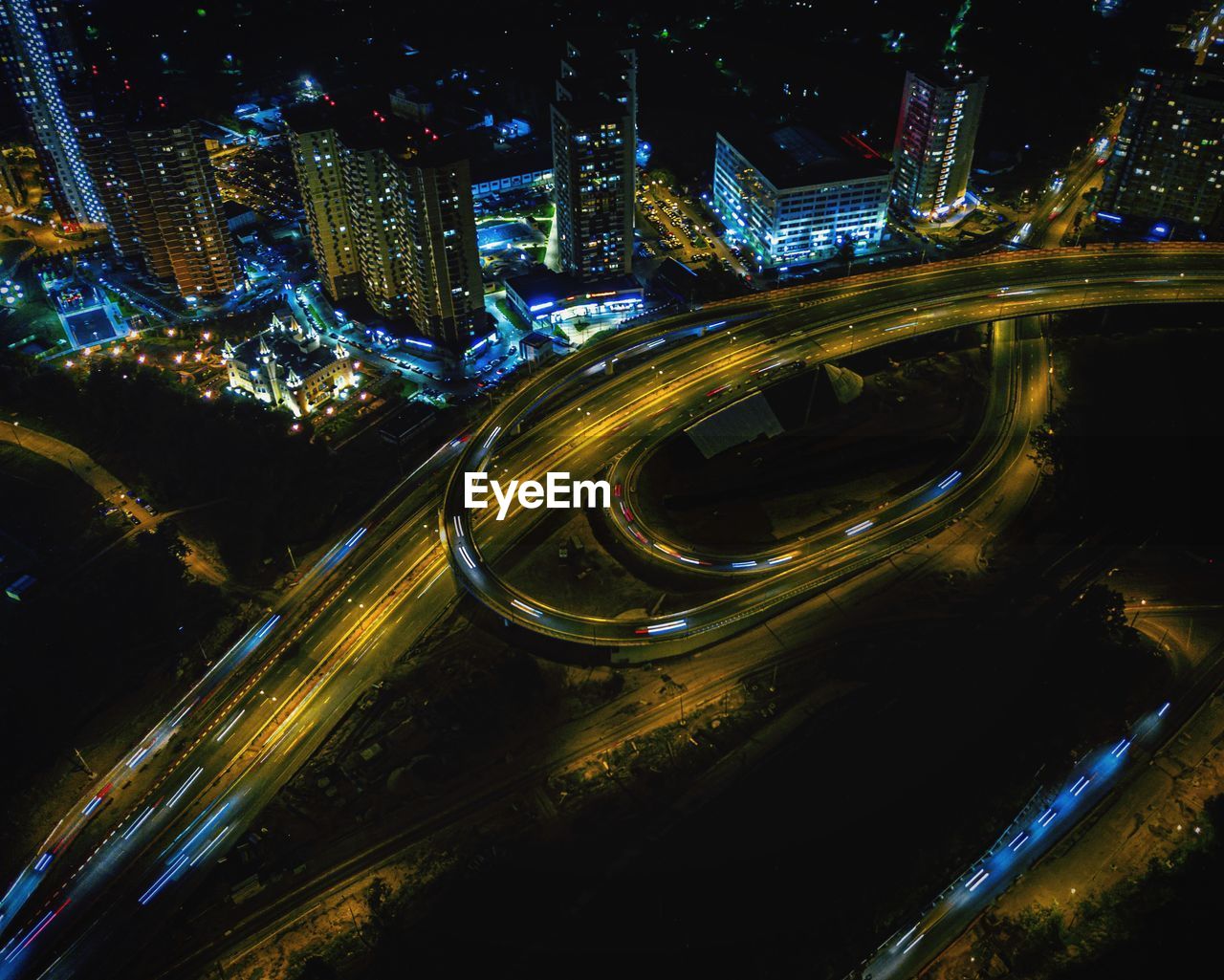 HIGH ANGLE VIEW OF LIGHT TRAILS ON HIGHWAY