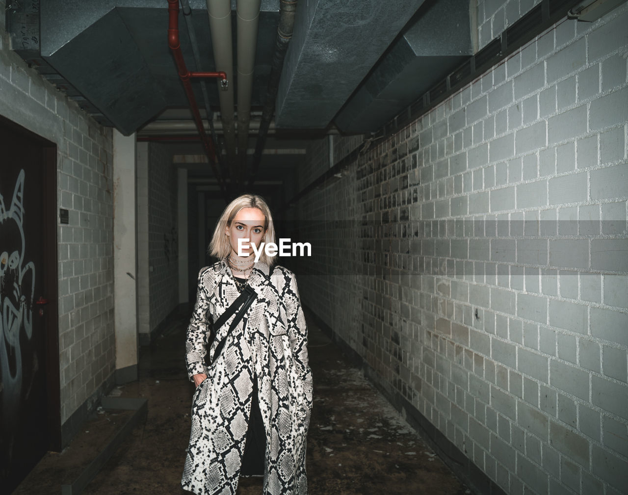 Portrait of young woman standing in tunnel