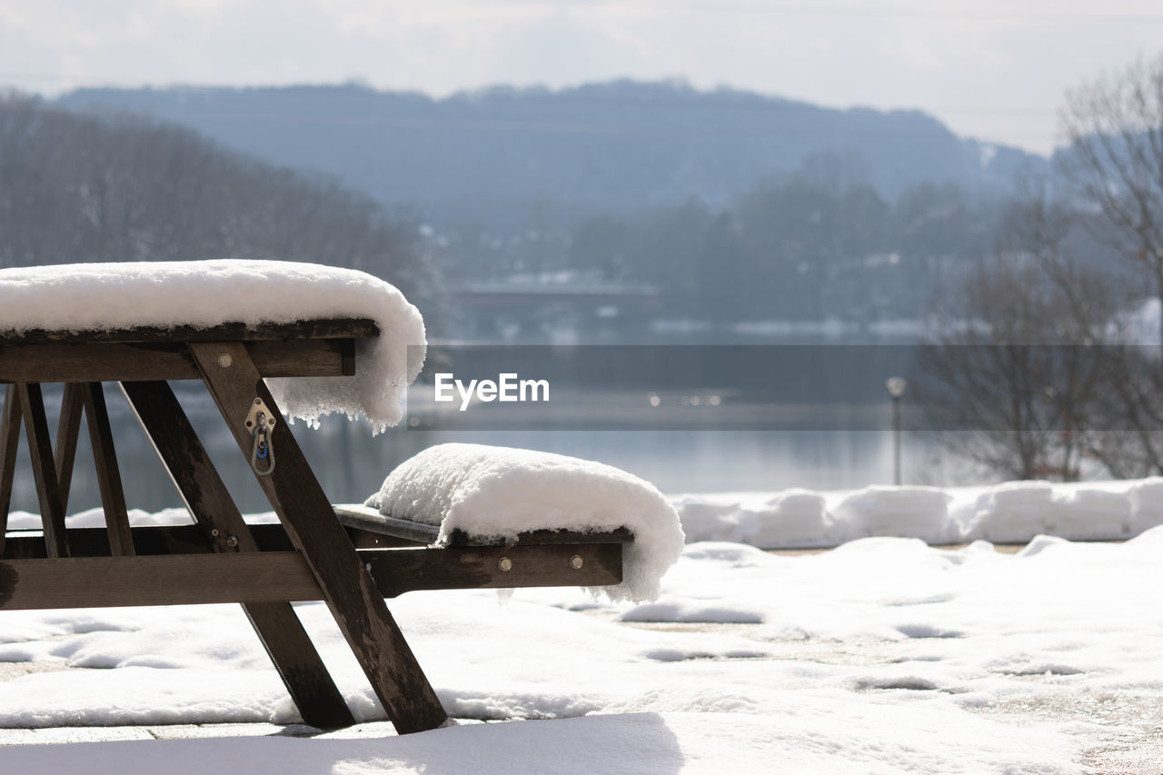 winter, snow, cold temperature, freezing, nature, frozen, ice, environment, water, scenics - nature, no people, mountain, beauty in nature, seat, white, tranquility, furniture, day, tranquil scene, landscape, outdoors, bench, relaxation, lake, wood, tree, land, blizzard, sky