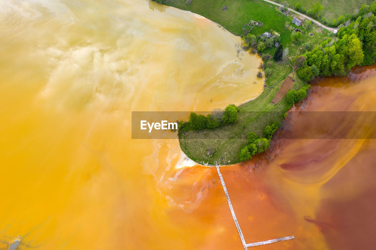 Aerial view of chemical mining waste residuals flooding into a settling basin. geamana, romania