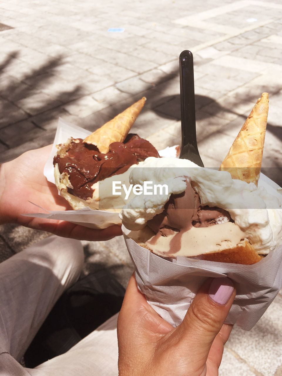 MIDSECTION OF PERSON HOLDING ICE CREAM