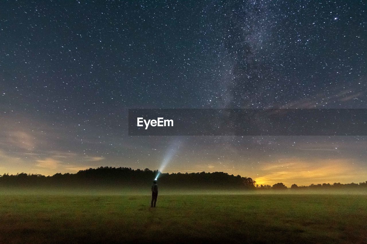 Scenic view of field against sky at night