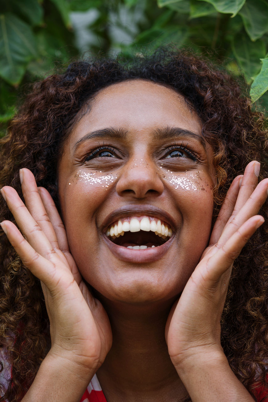 Portrait of a black woman with afro hair and glitter on her face