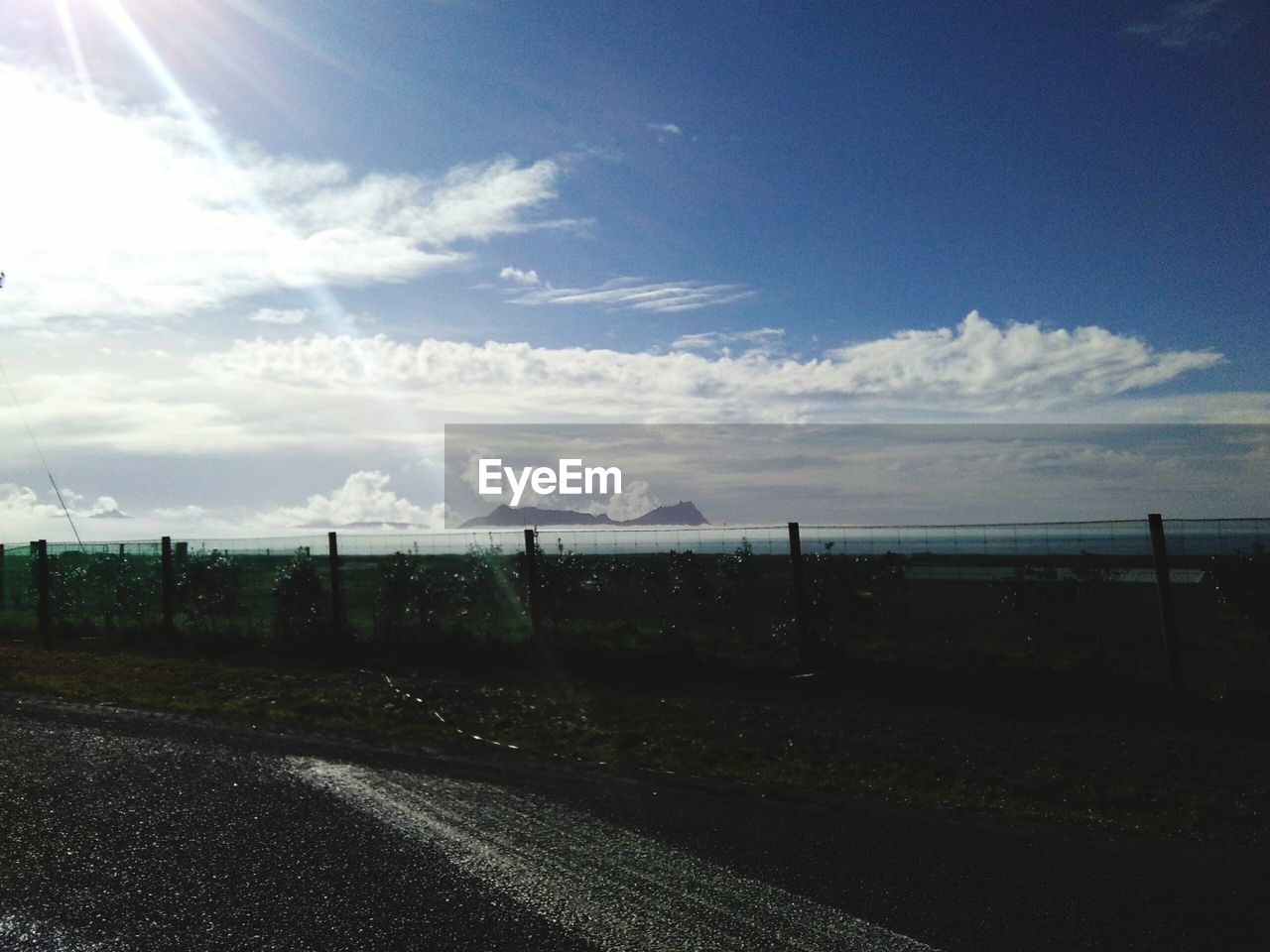 Road by landscape against sky