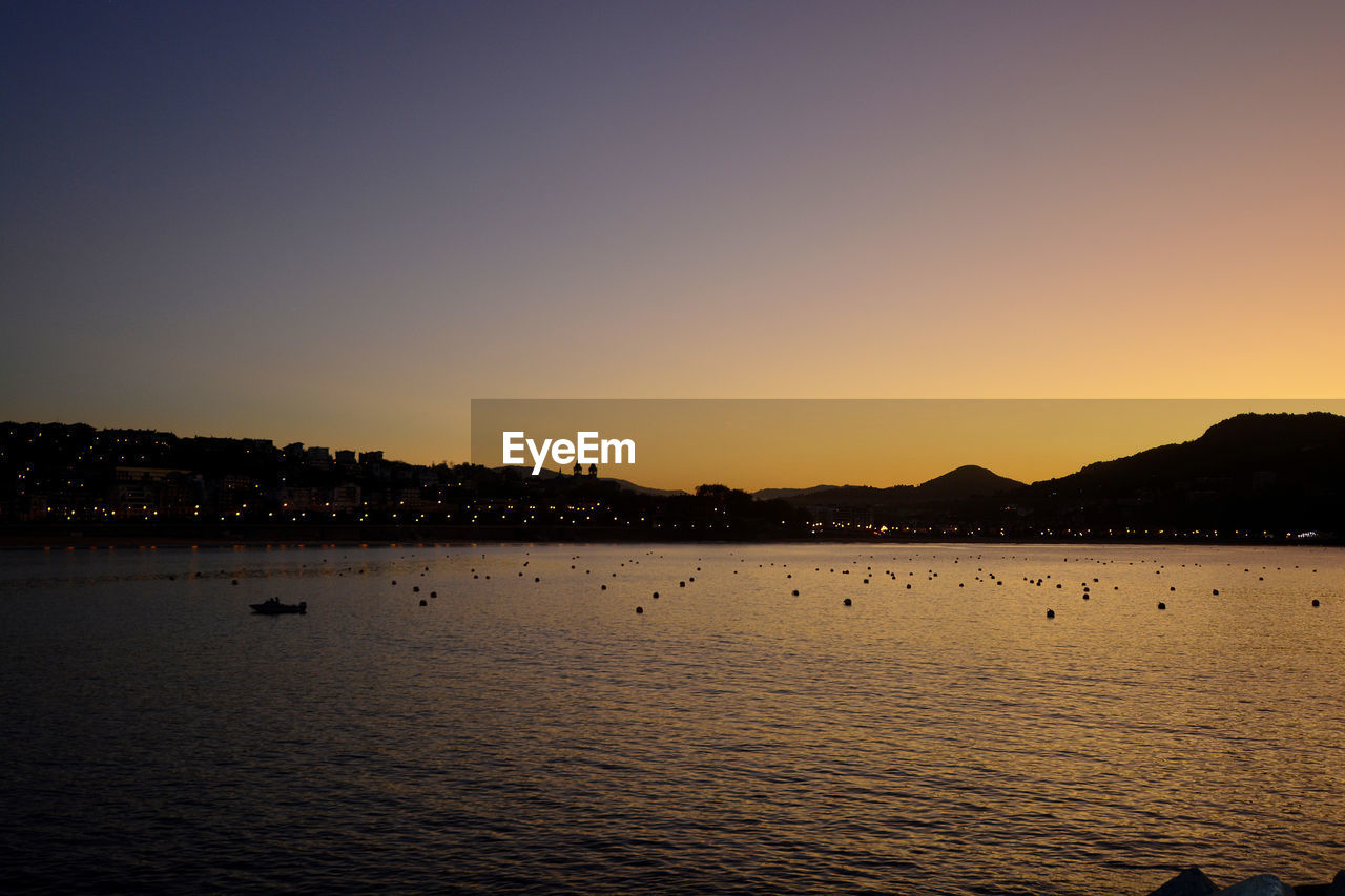 Scenic view of sea against clear sky during sunset