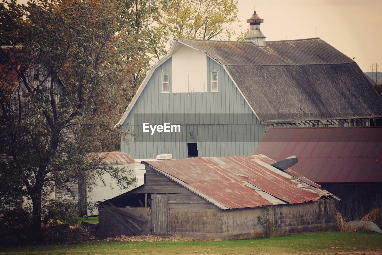 Old barn on field by building