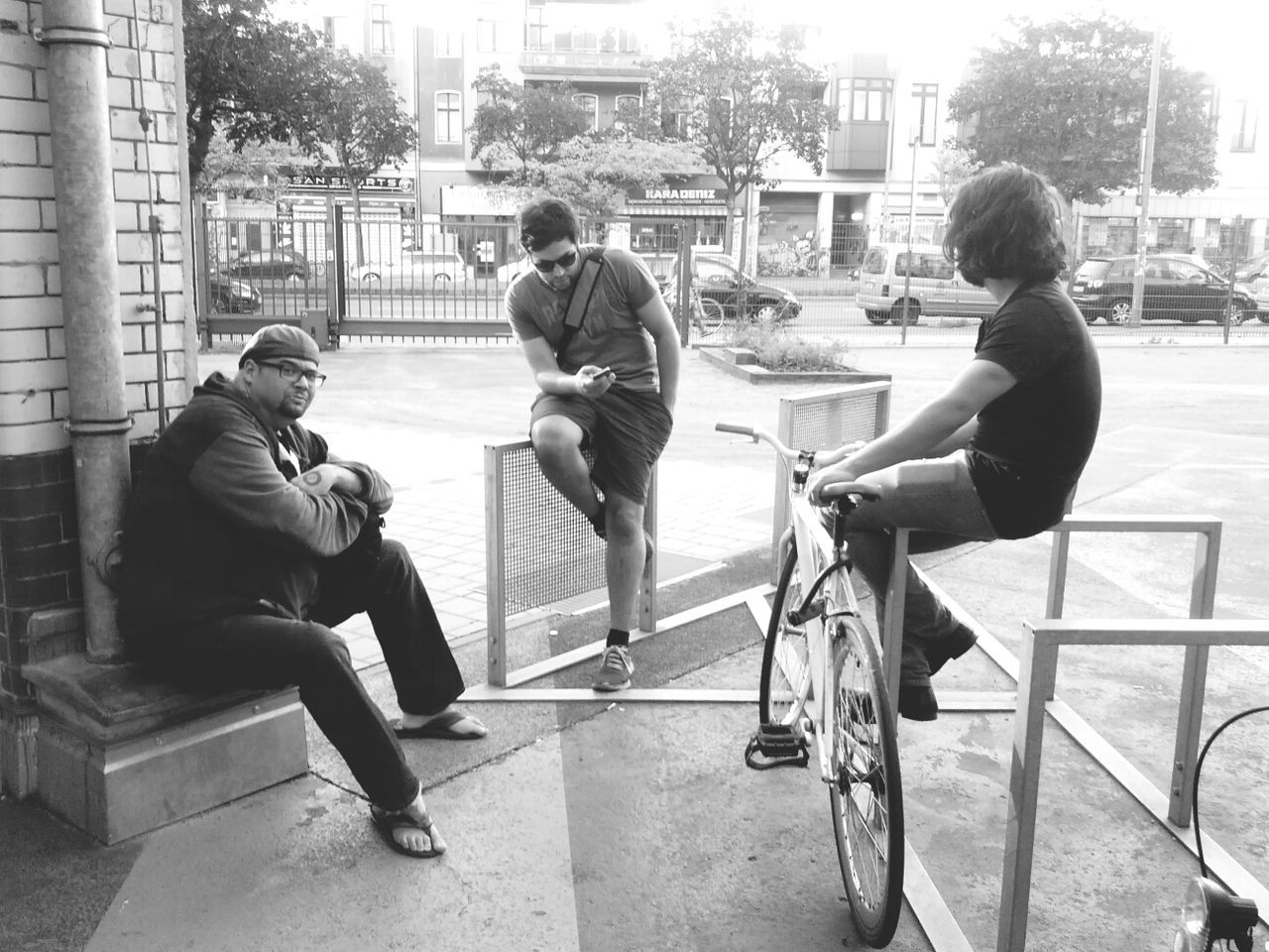 Three young men sitting outdoors