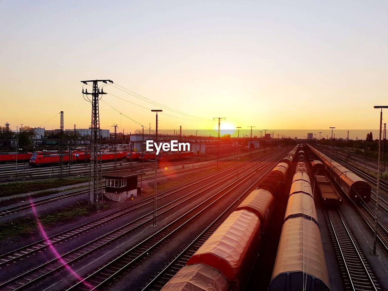 High angle view of trains on railroad track against sky during sunset