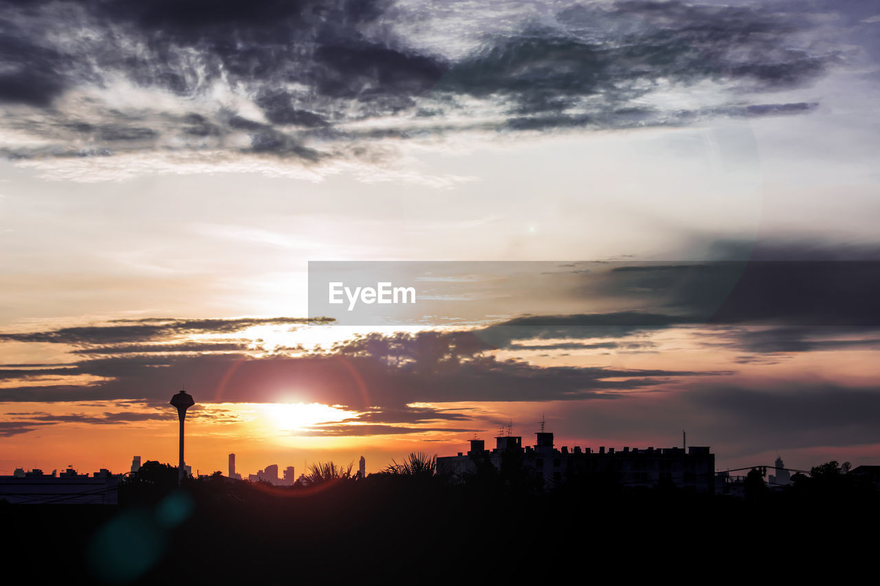 Silhouette of city during sunset