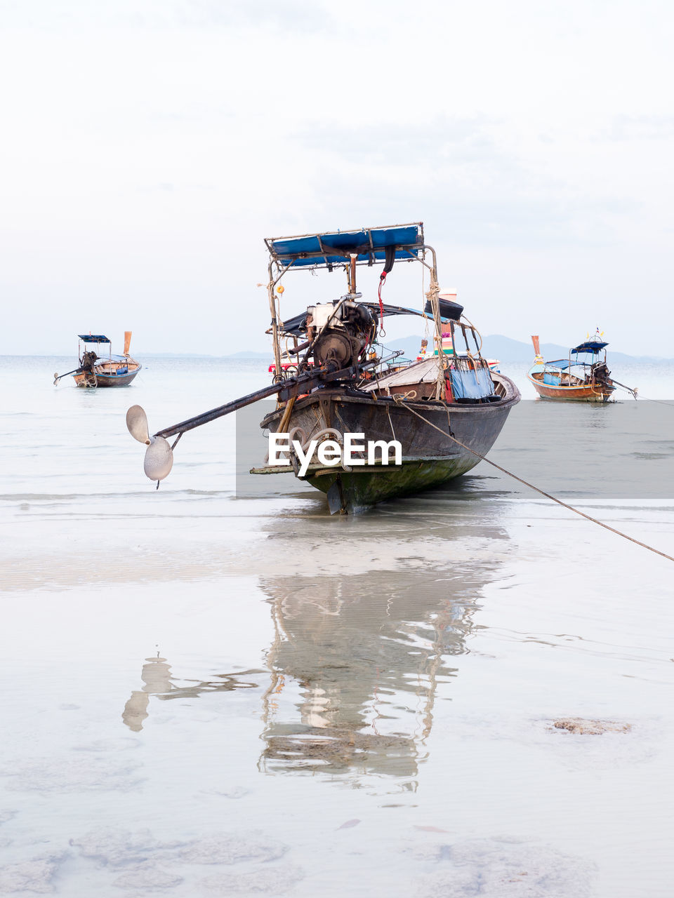 Boats in calm sea against the sky