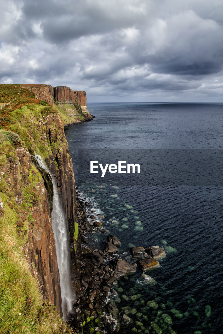 Aerial view of coastline against stormy sky