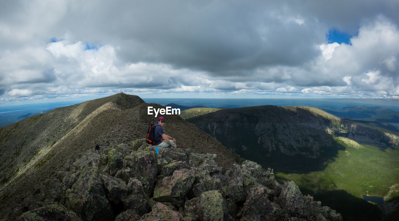 Man sitting on rocks at mount katahdin