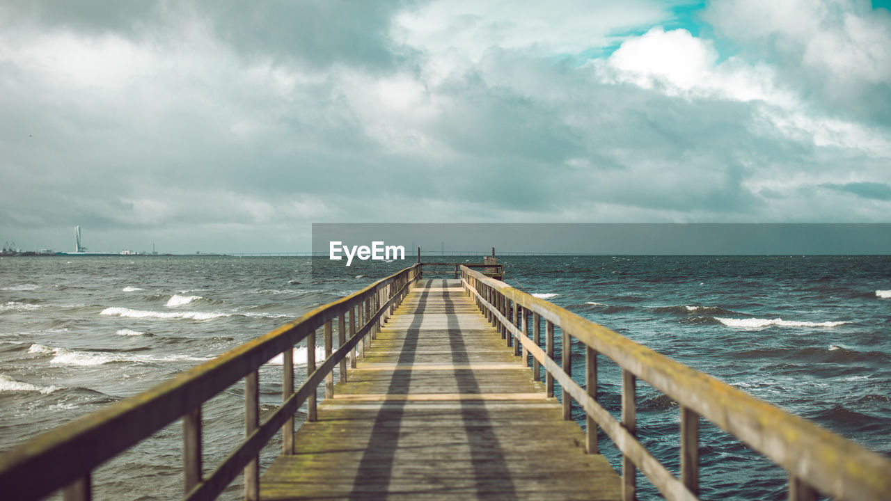 Pier on sea against sky