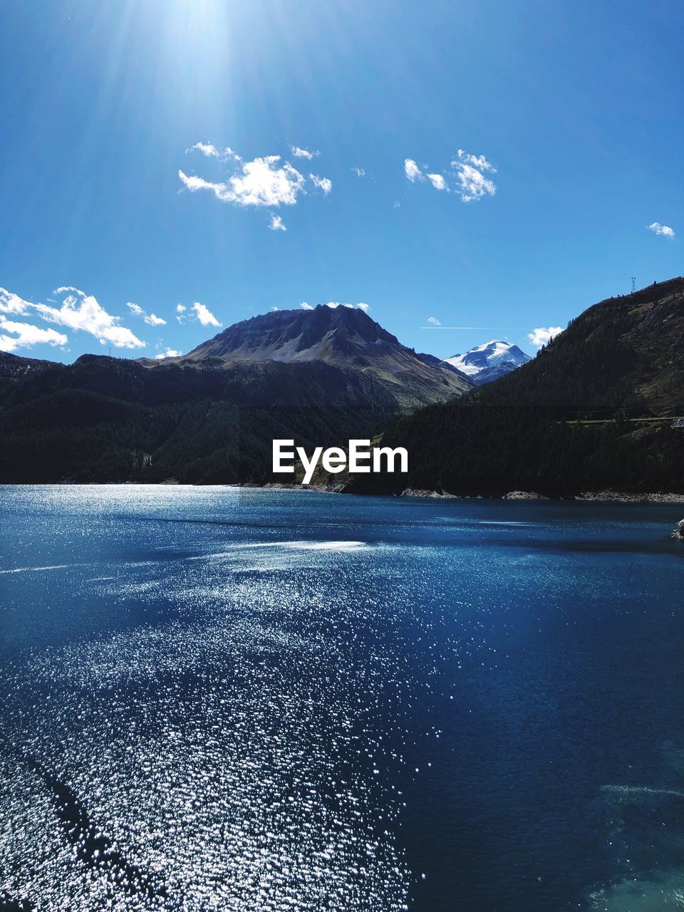 Scenic view of lake and mountains against sky