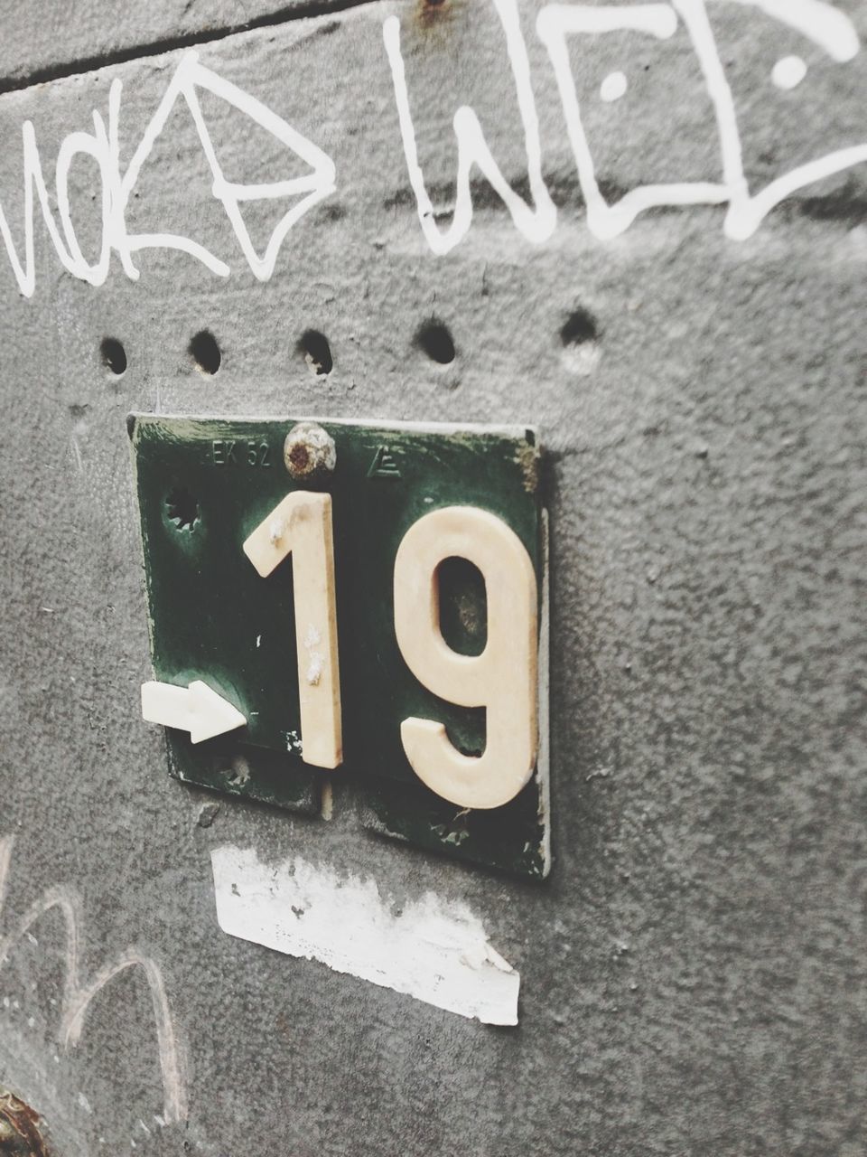 Close-up of number plate on wall