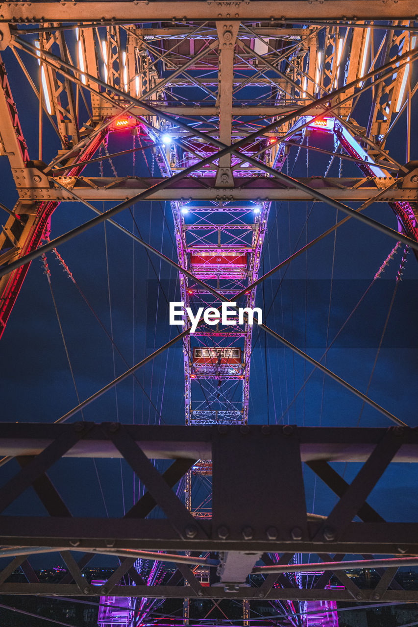 Illuminated ferris wheel at night