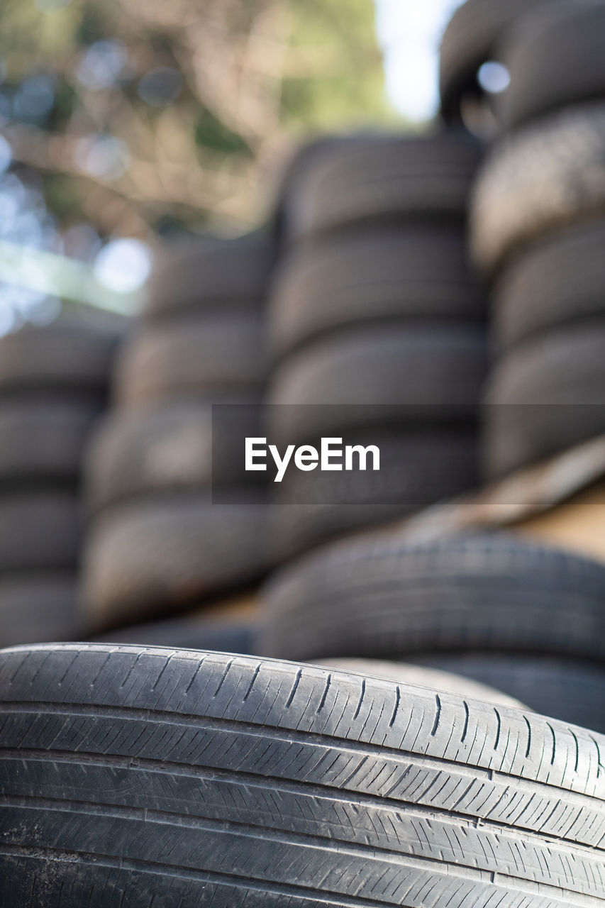 Old used rubber tires stacked with high piles. hazardous waste requiring recycling and disposal.