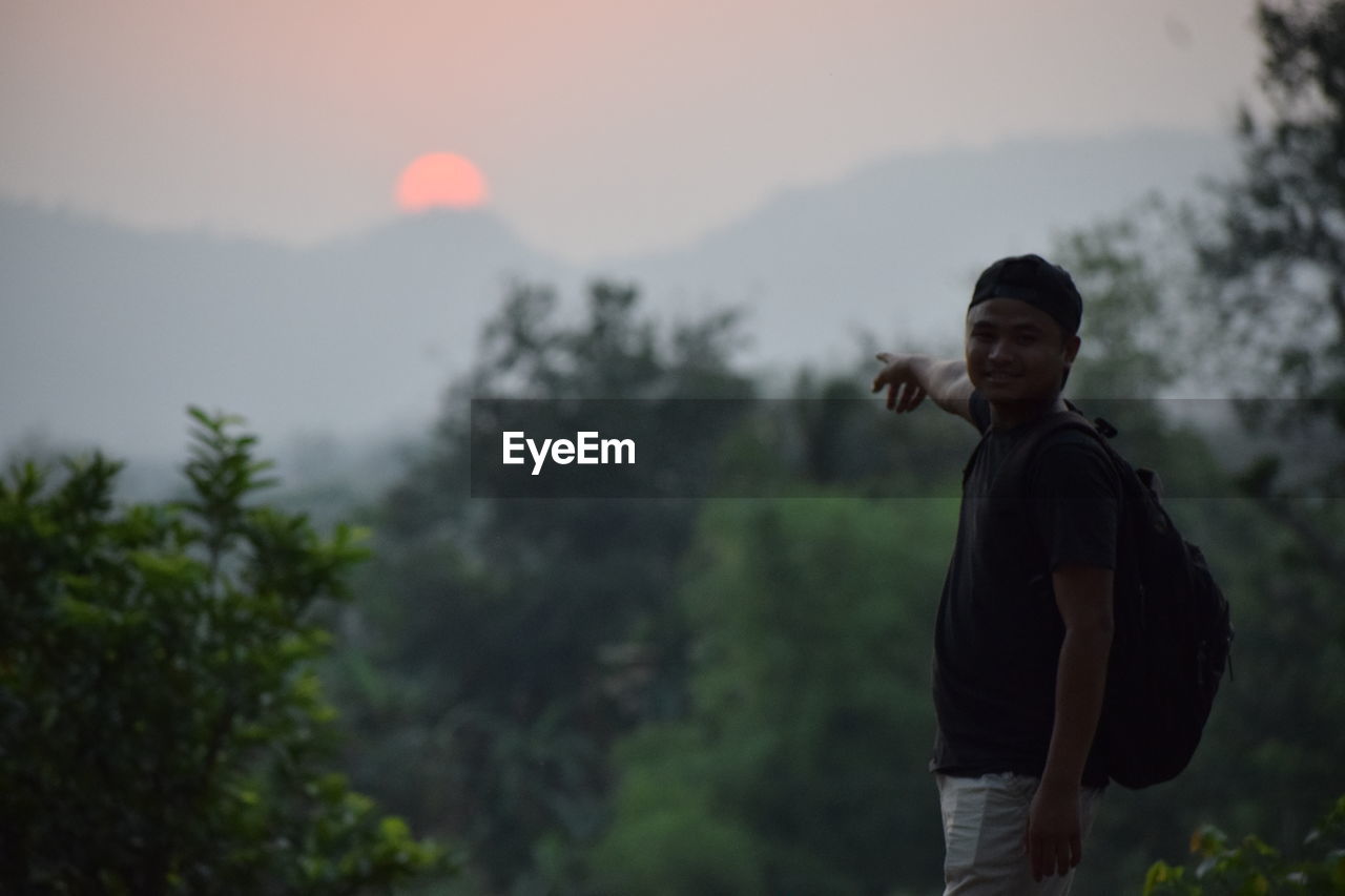 Man standing on mountain against sky