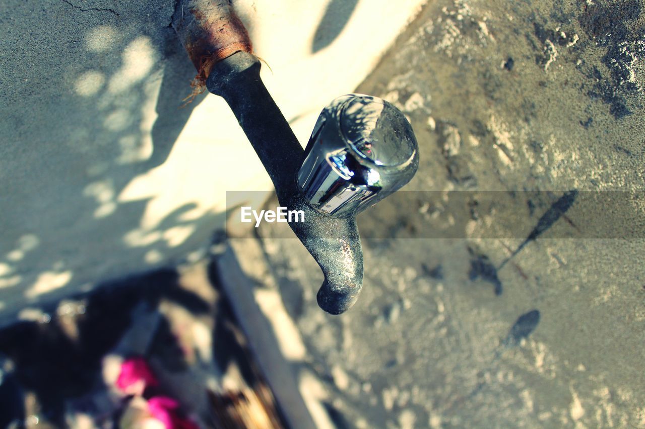 High angle view of old-fashioned tap on wall