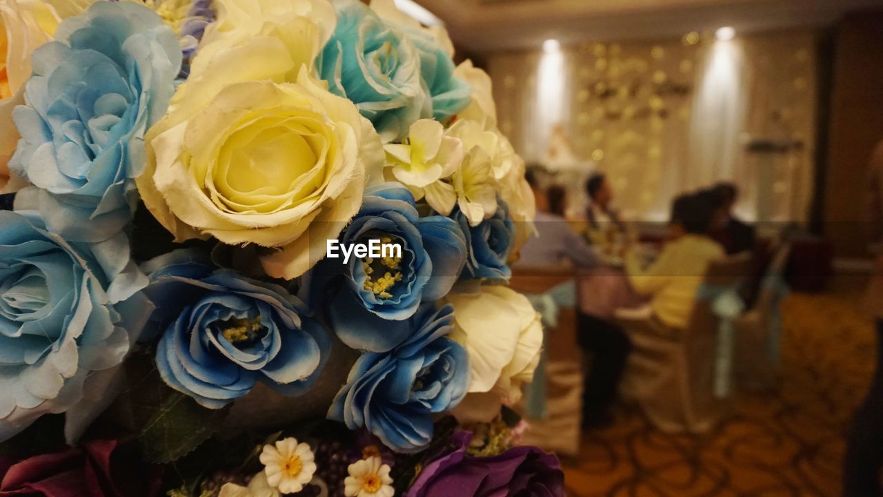 HIGH ANGLE VIEW OF PEOPLE HOLDING BOUQUET OF ROSES