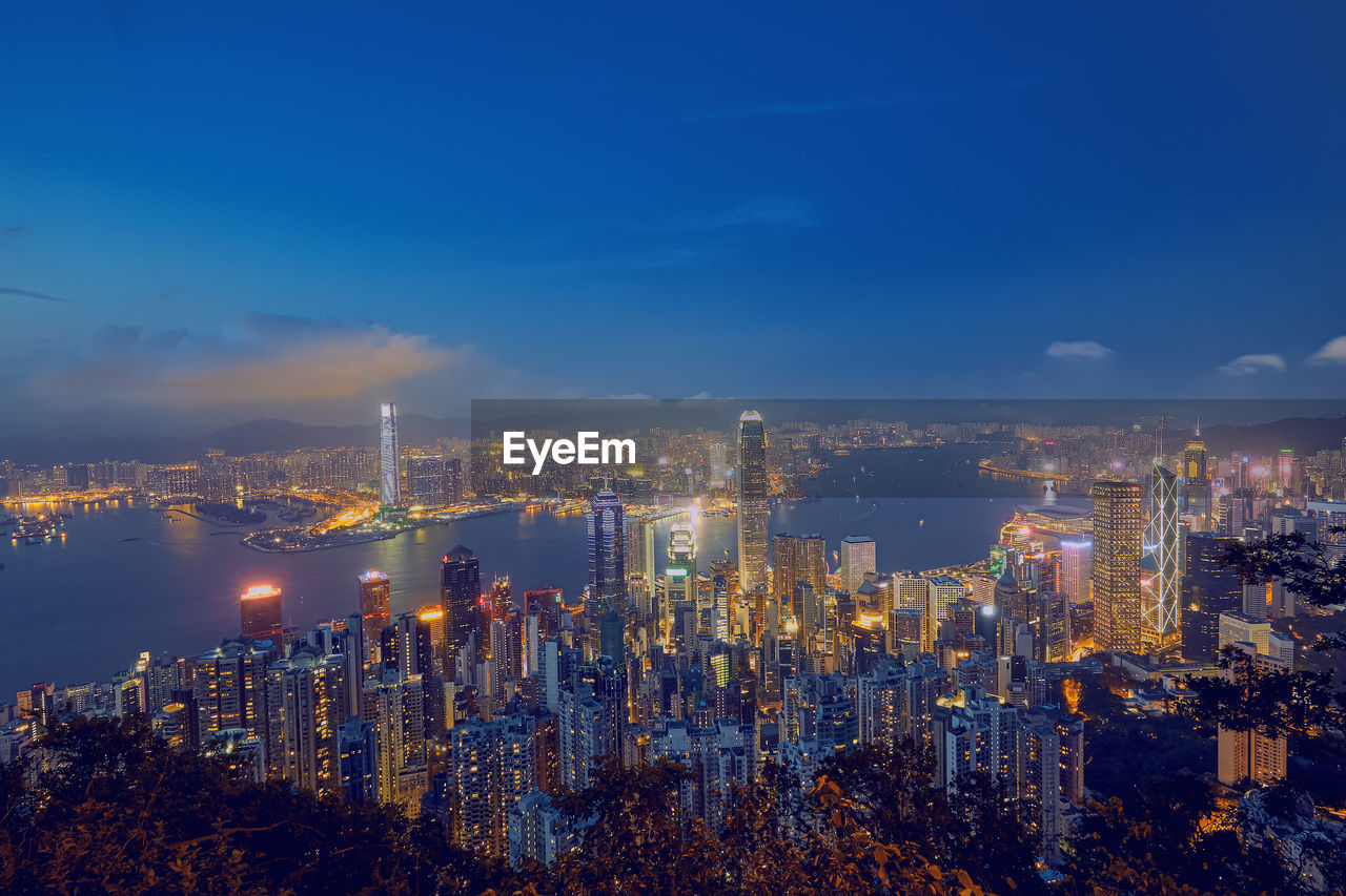 High angle view of illuminated buildings against sky at night
