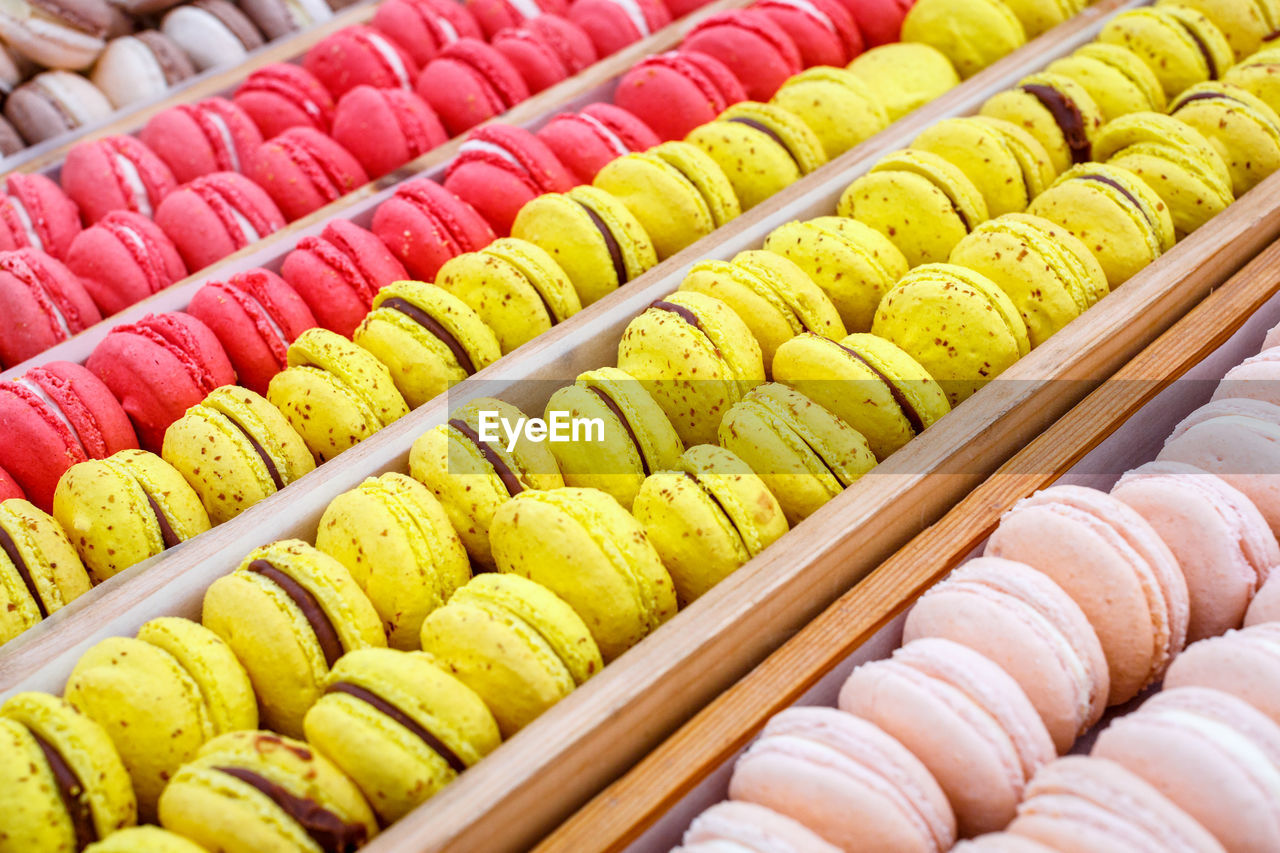 Colorful french macarons in wooden trays, close up