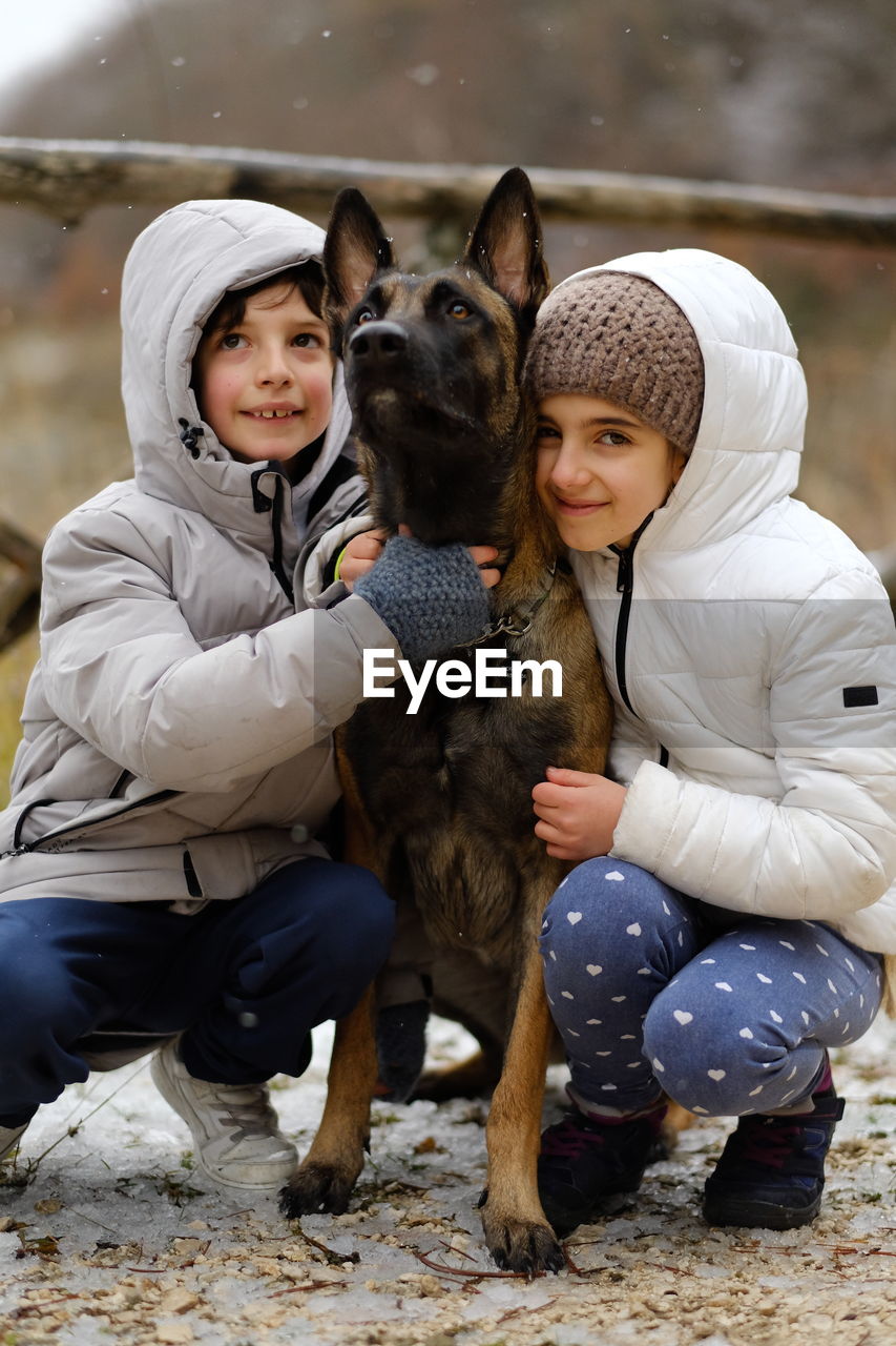 Portrait of kids with dog belgian malinois