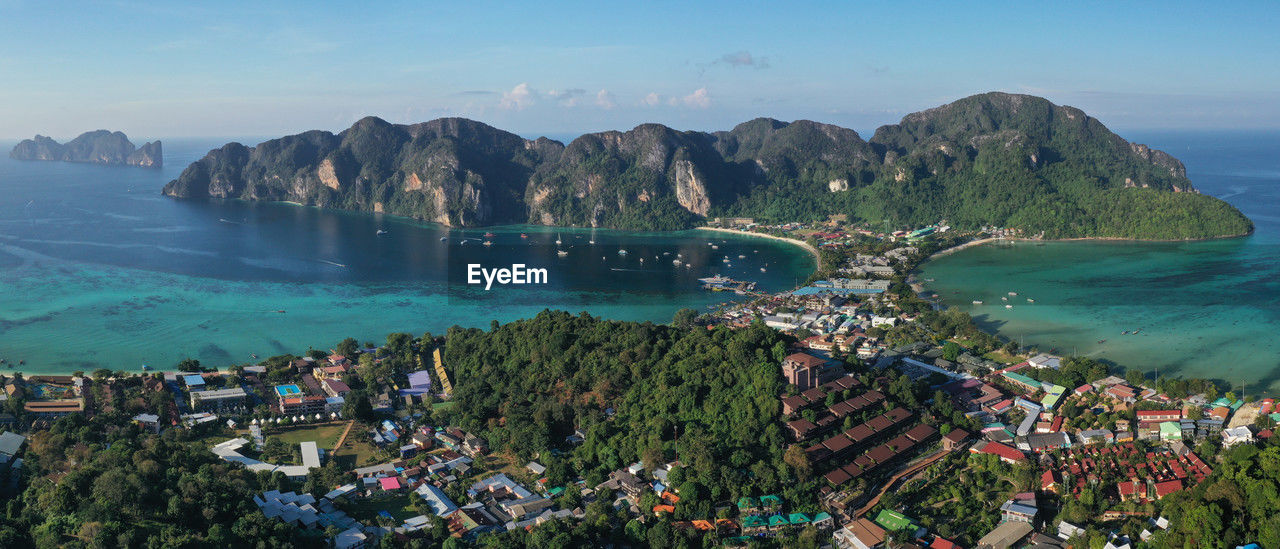 high angle view of city by sea against sky