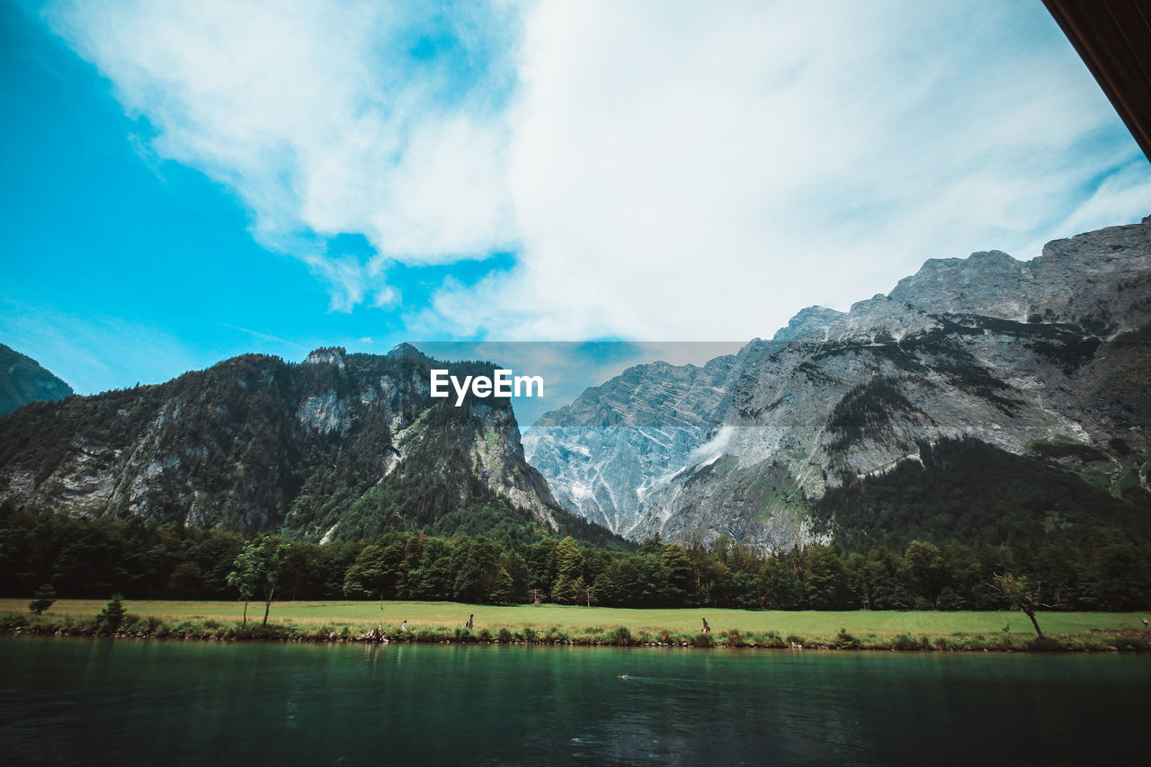 Scenic view of lake and mountains against sky