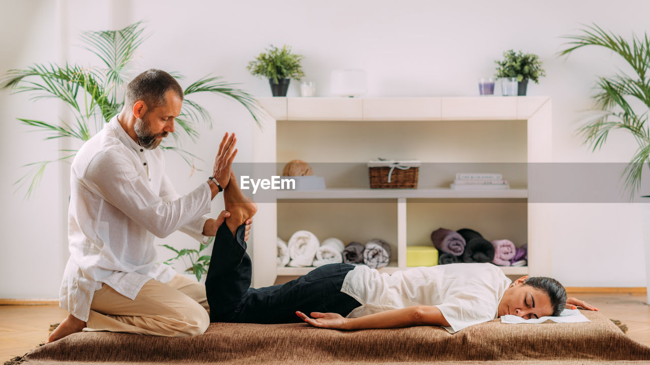Therapist stretching womans foot. shiatsu massage.