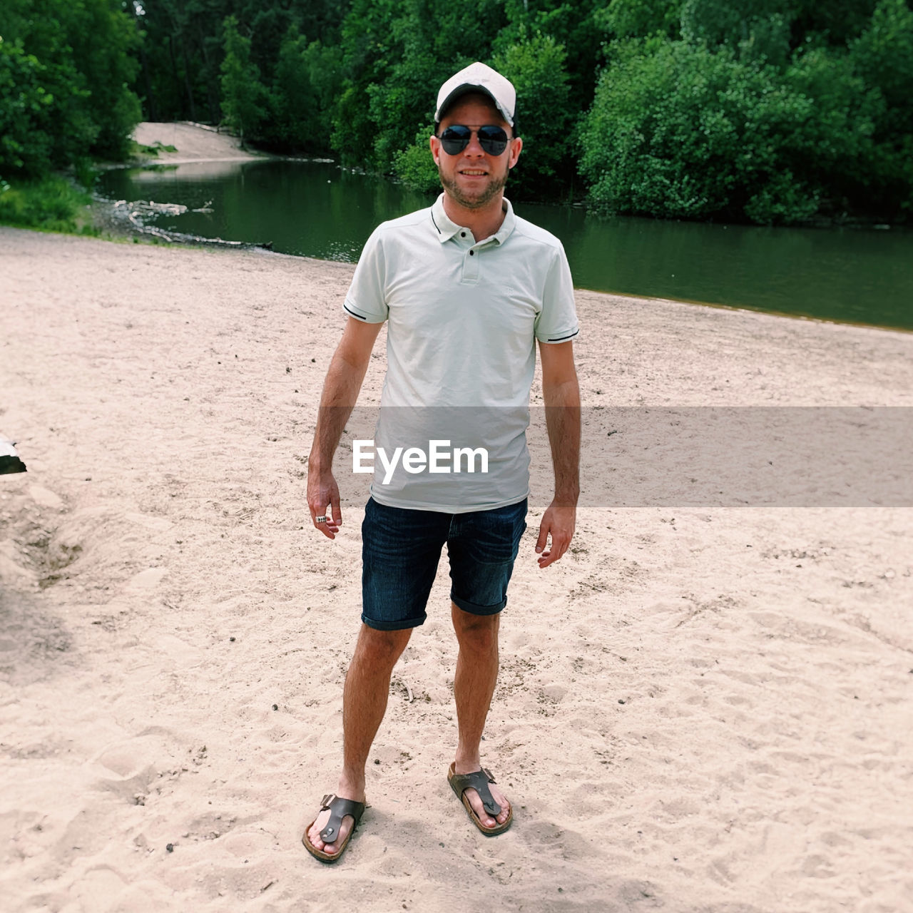 full length portrait of young man standing on beach