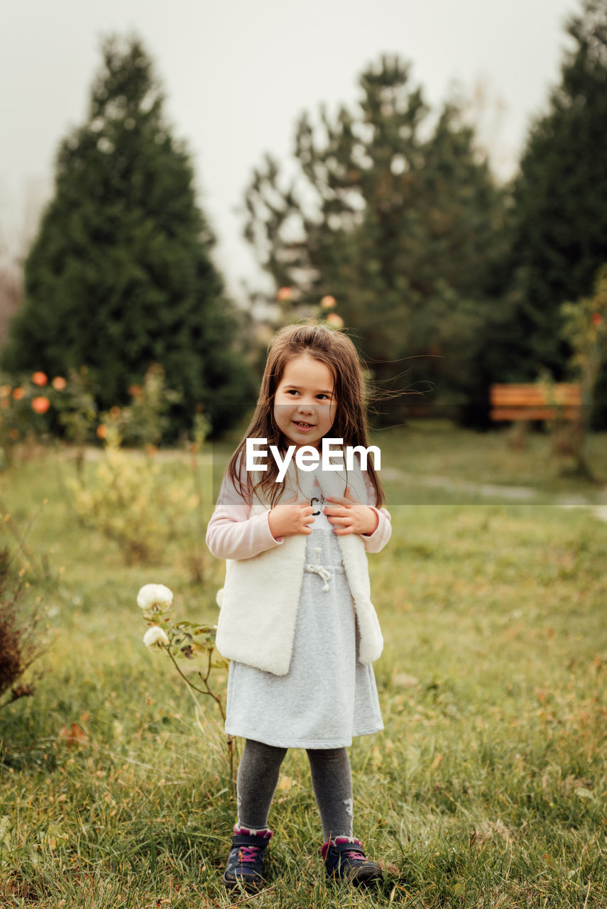 Portrait of girl standing on field