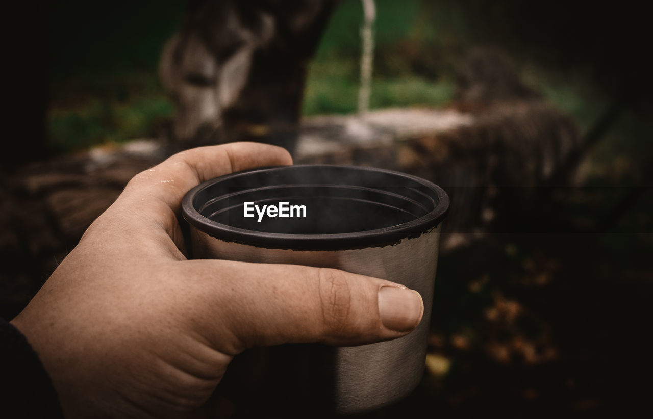 Cropped hand of person holding cup