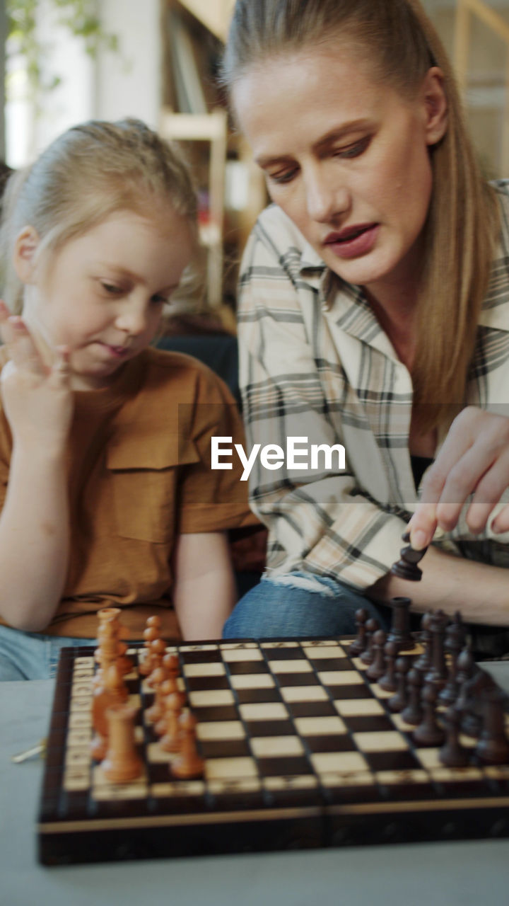 Mother and daughter playing chess