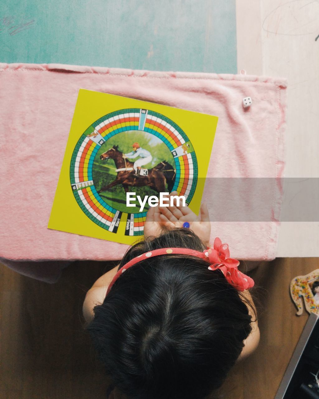 Directly above view of girl playing board game at home