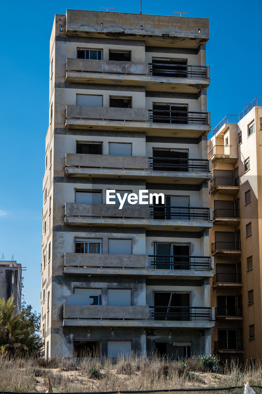 architecture, tower block, building exterior, built structure, residential area, building, condominium, city, residential district, sky, neighbourhood, apartment, blue, urban area, facade, no people, window, nature, construction industry, house, industry, outdoors, day, low angle view, clear sky, skyscraper, tower, home ownership
