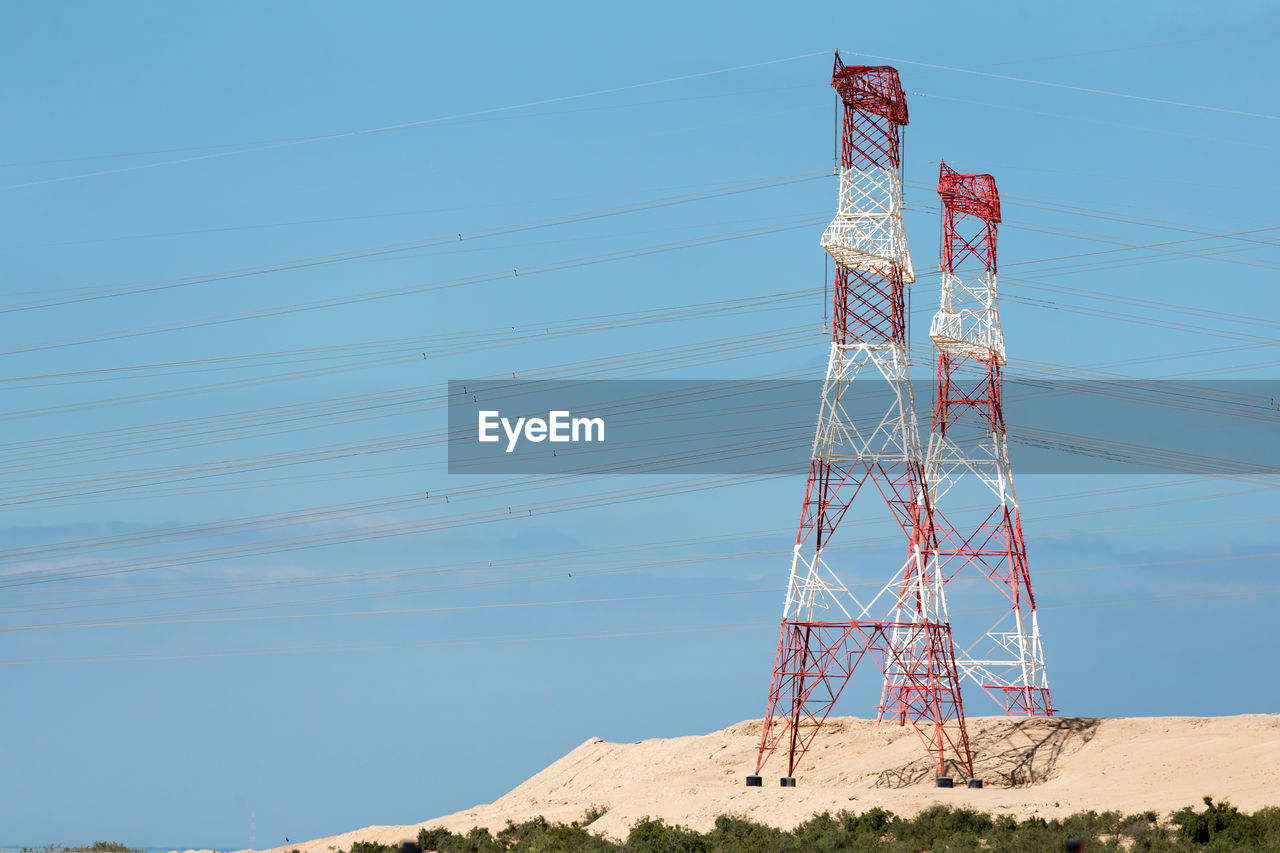 LOW ANGLE VIEW OF ELECTRICITY PYLON ON LAND AGAINST SKY