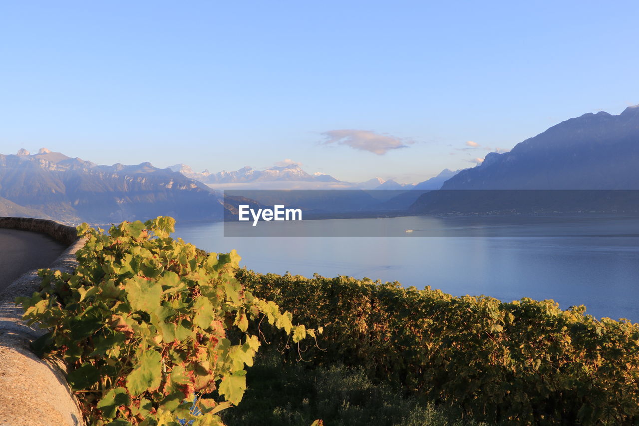 Scenic view of sea and mountains against sky