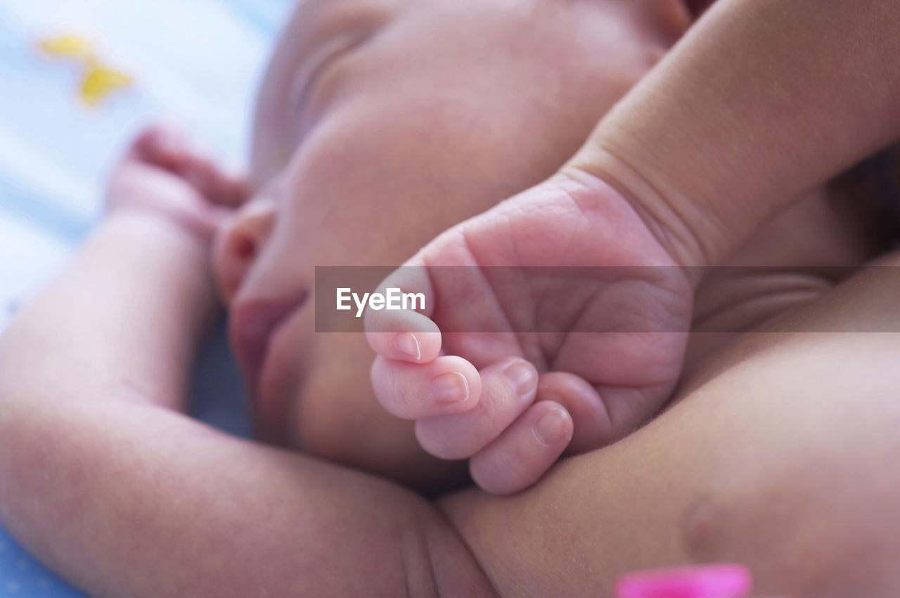 High angle view of baby sleeping on bed at home