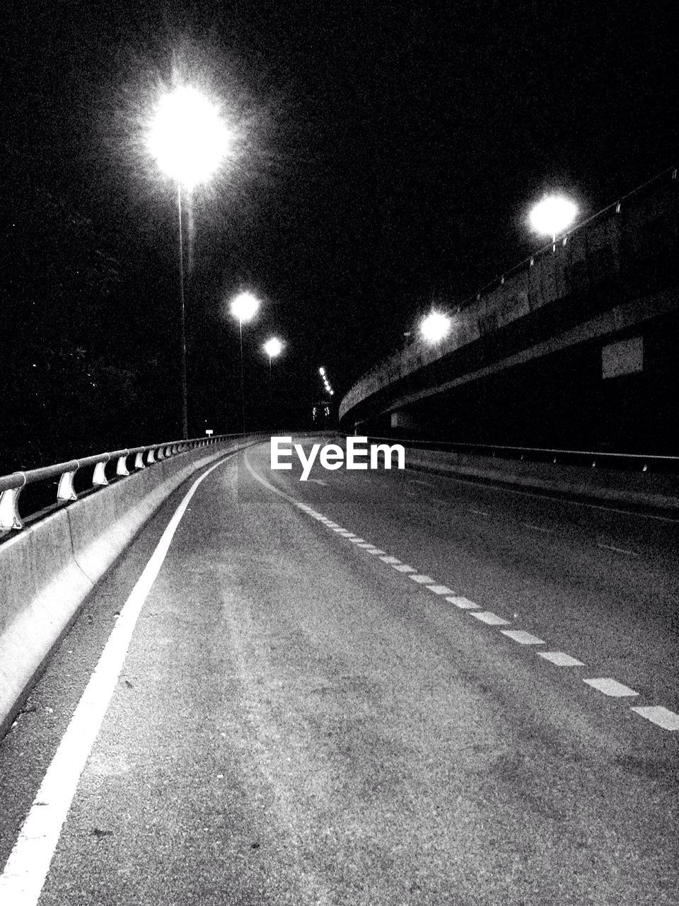 ILLUMINATED ROAD AT NIGHT