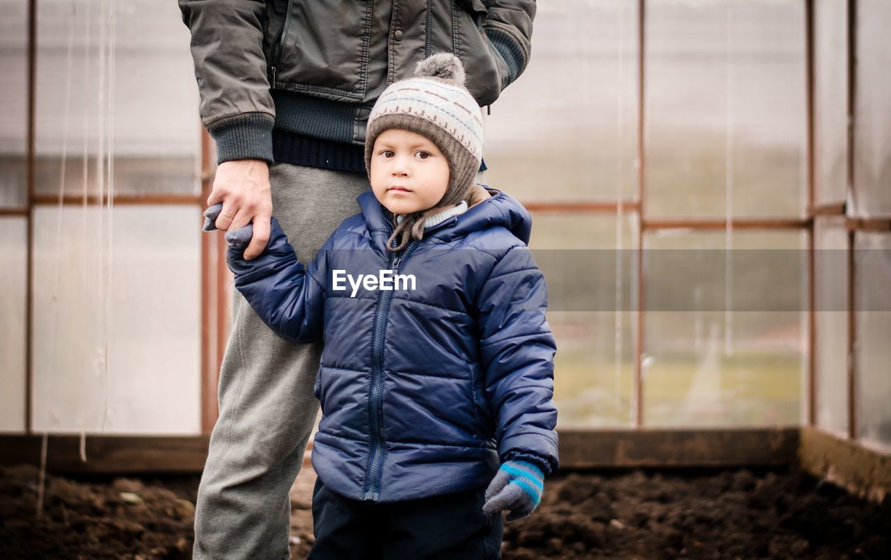 Portrait of boy standing with father