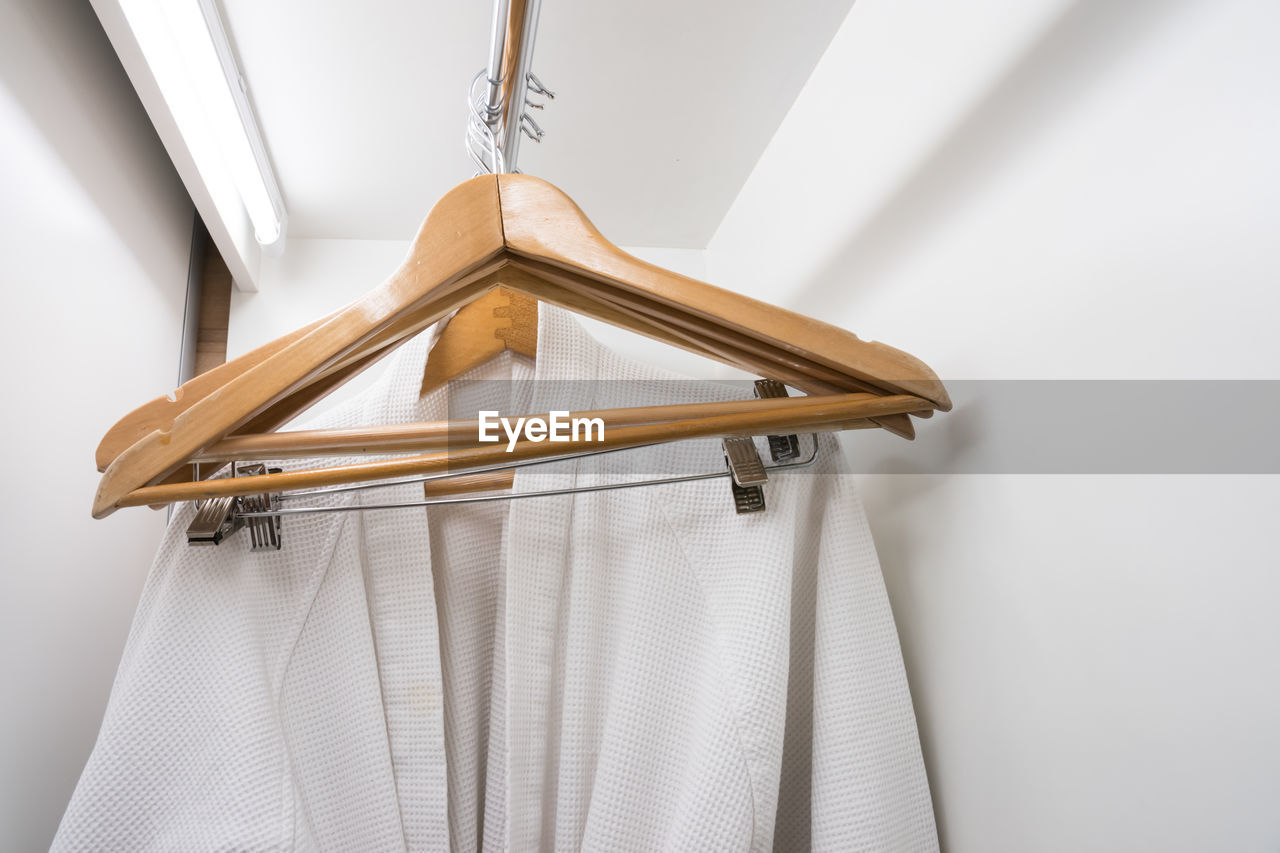 Close-up of clothes hanging on wall at home