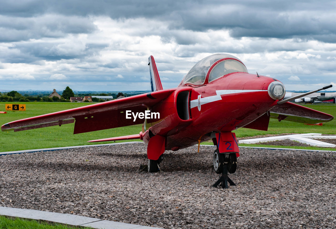 RED AIRPLANE ON RUNWAY