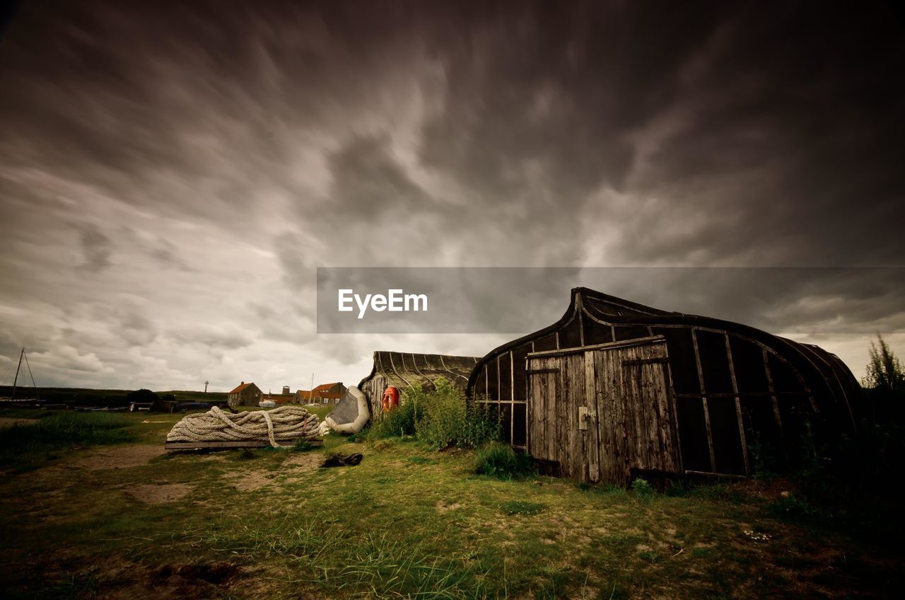 Wooden sheds with gloomy sky