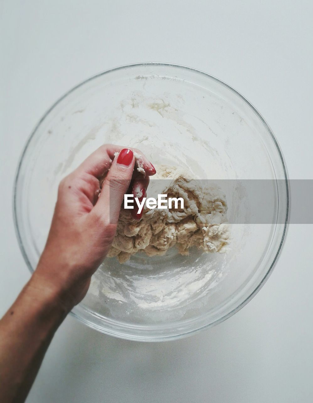 Directly above shot of woman kneading dough at table