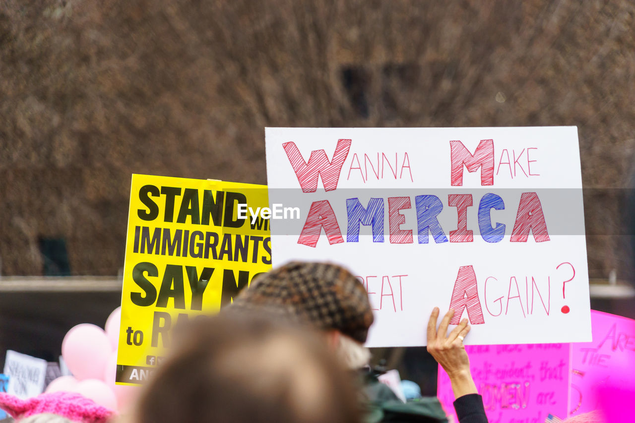 People with text on placard in city during protest