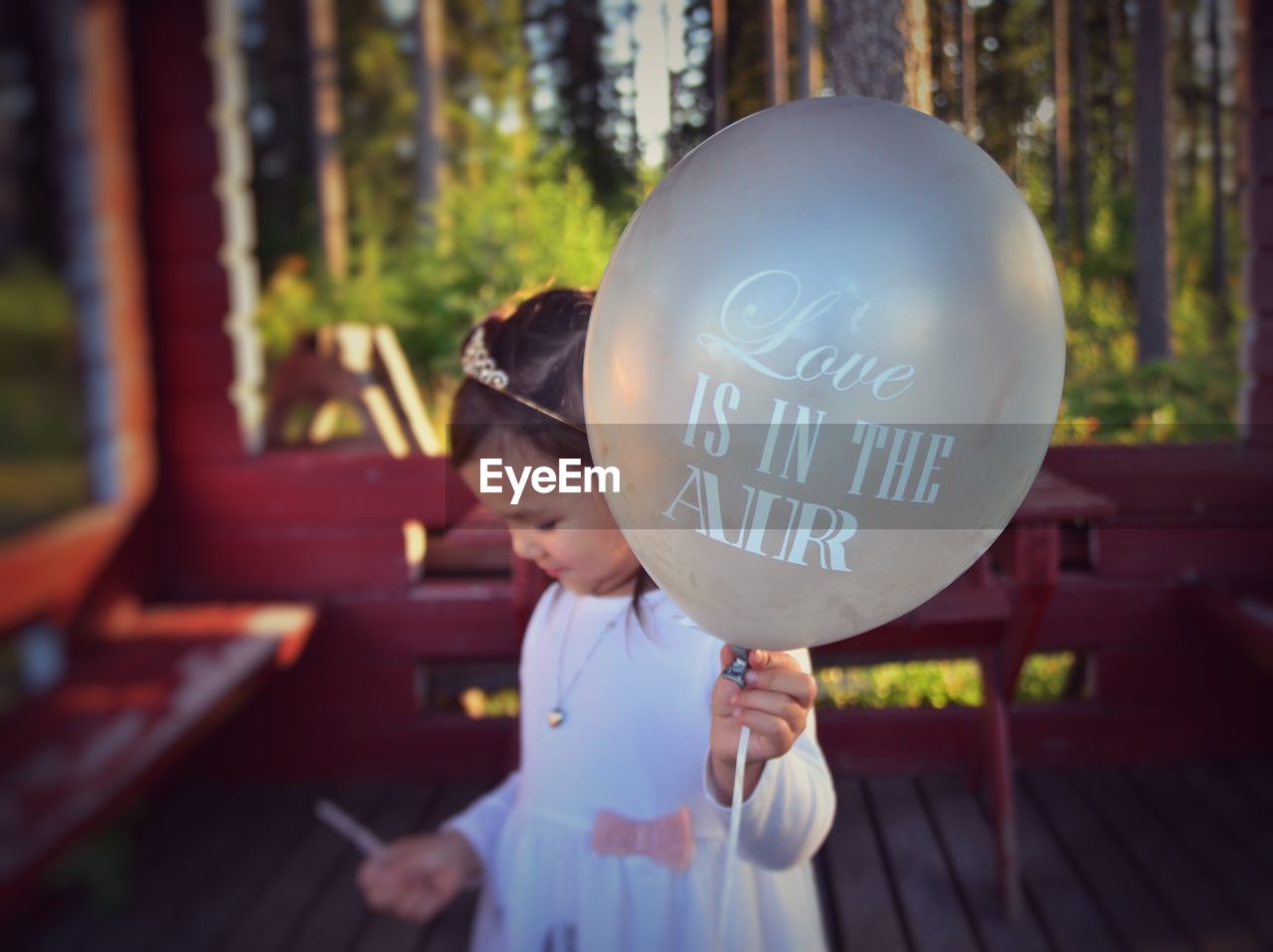 Girl holding balloon with text