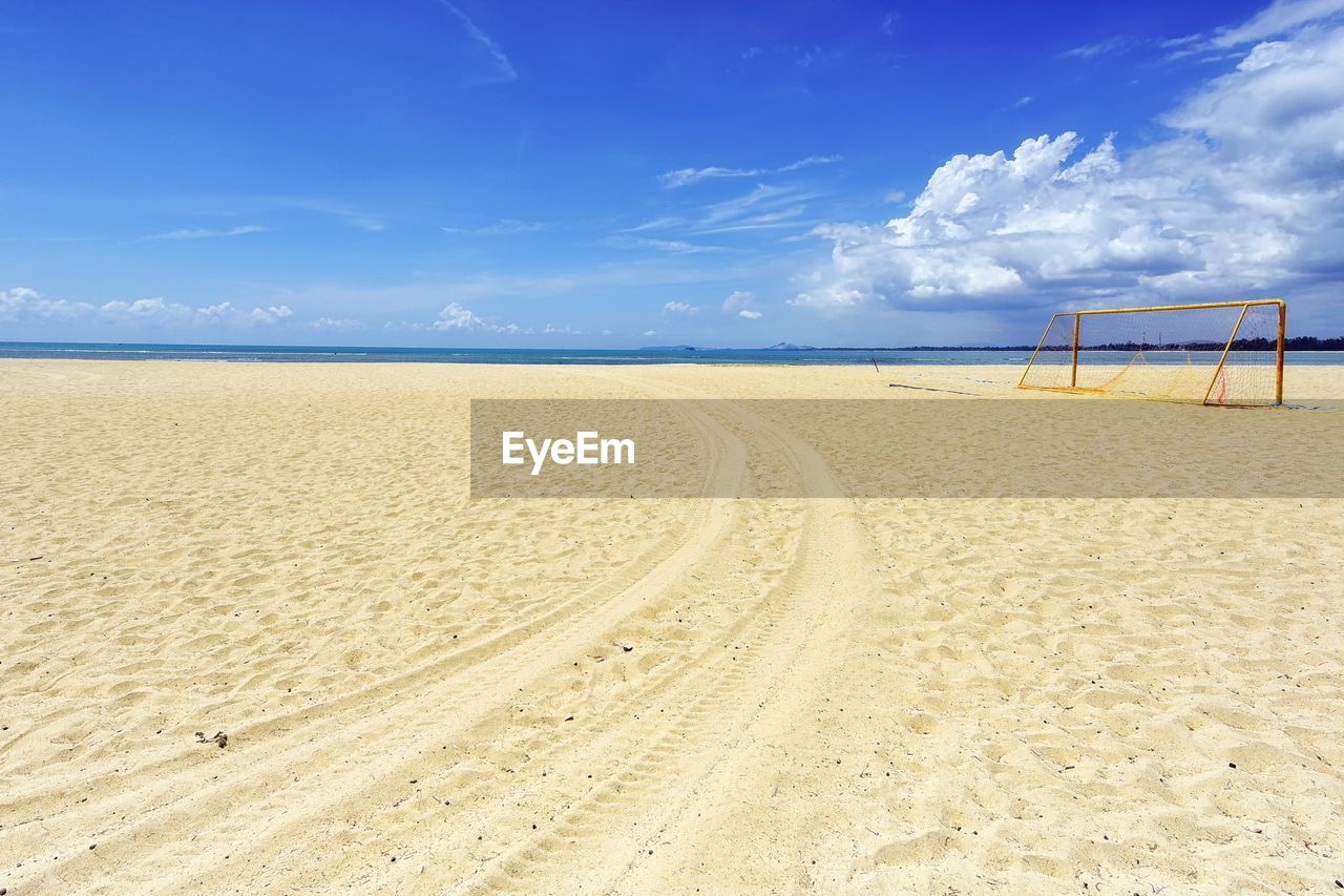 Scenic view of beach against blue sky