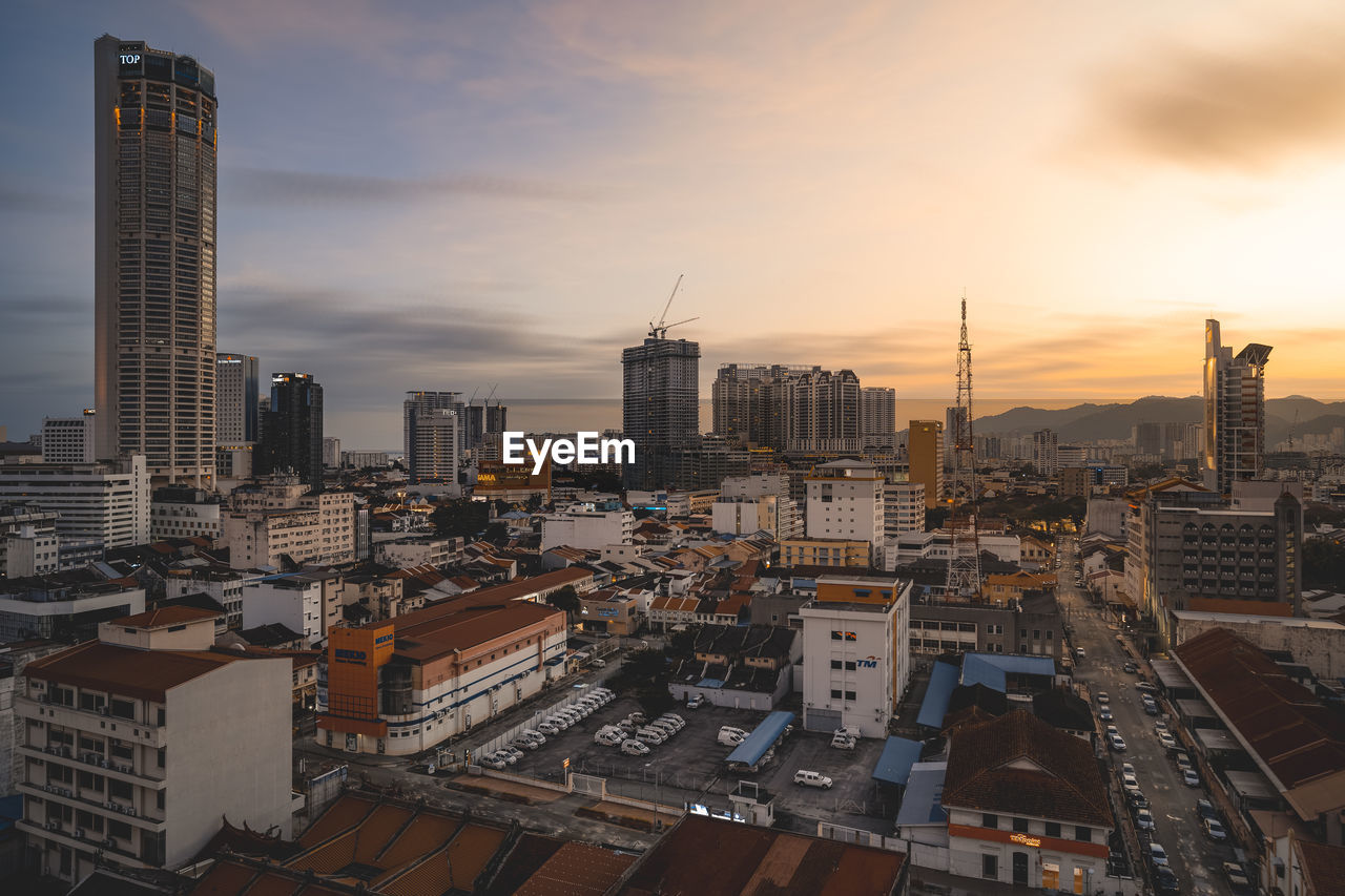 High angle view of buildings in city against sky during sunset