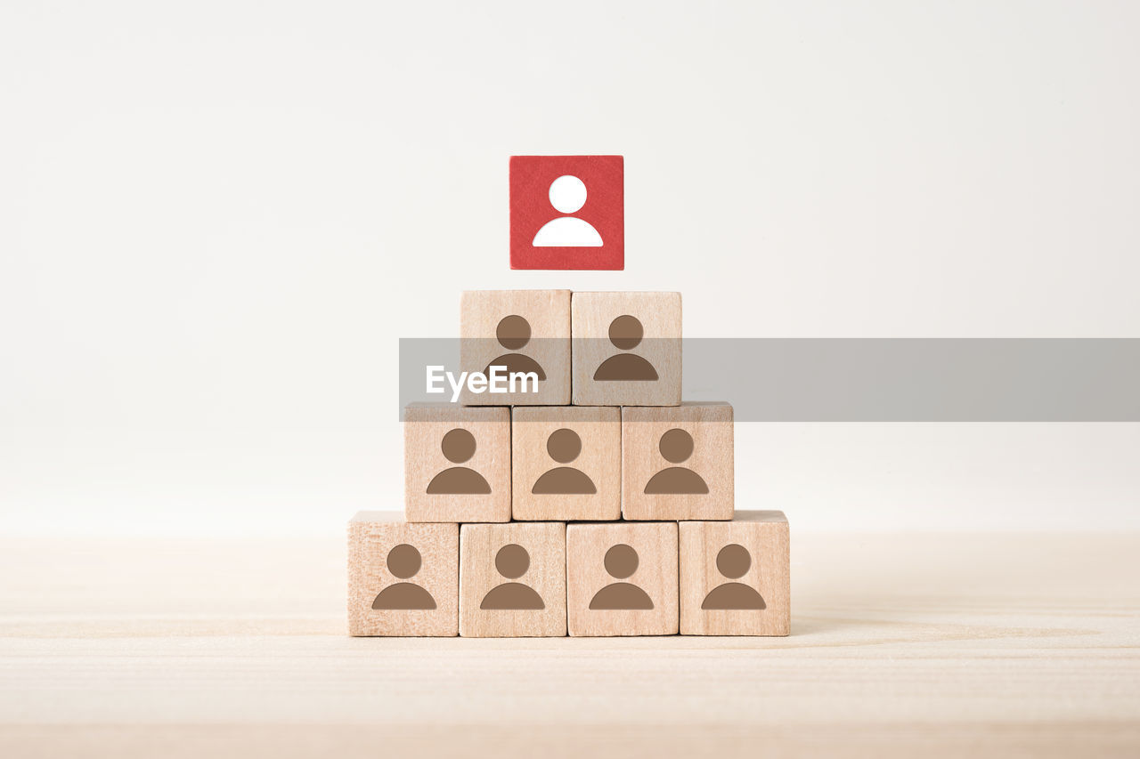 Close-up of wooden cubes on table against white background